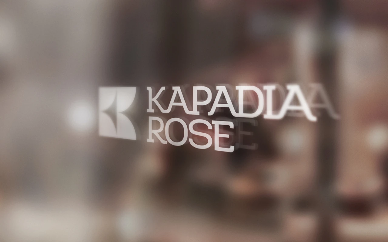 Kapadia Rose logo applied to frosted glass in an office setting