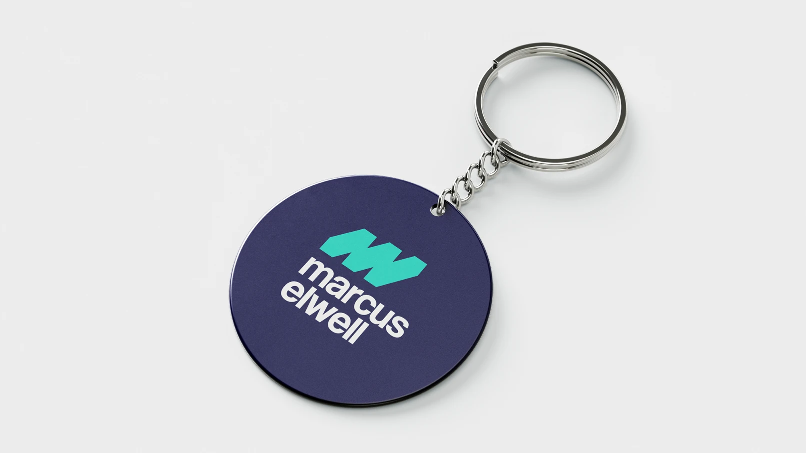 Marcus Elwell branded keyring with navy background and teal logo