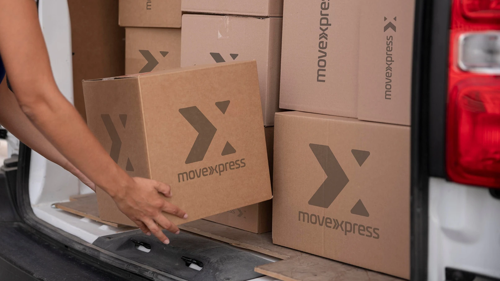 MoveXpress branded cardboard shipping boxes inside delivery van