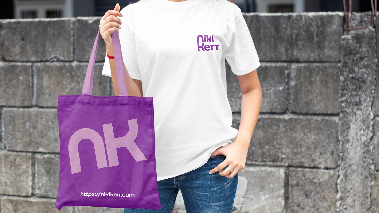Niki Kerr branded tote bag and t-shirt featuring purple NK logo